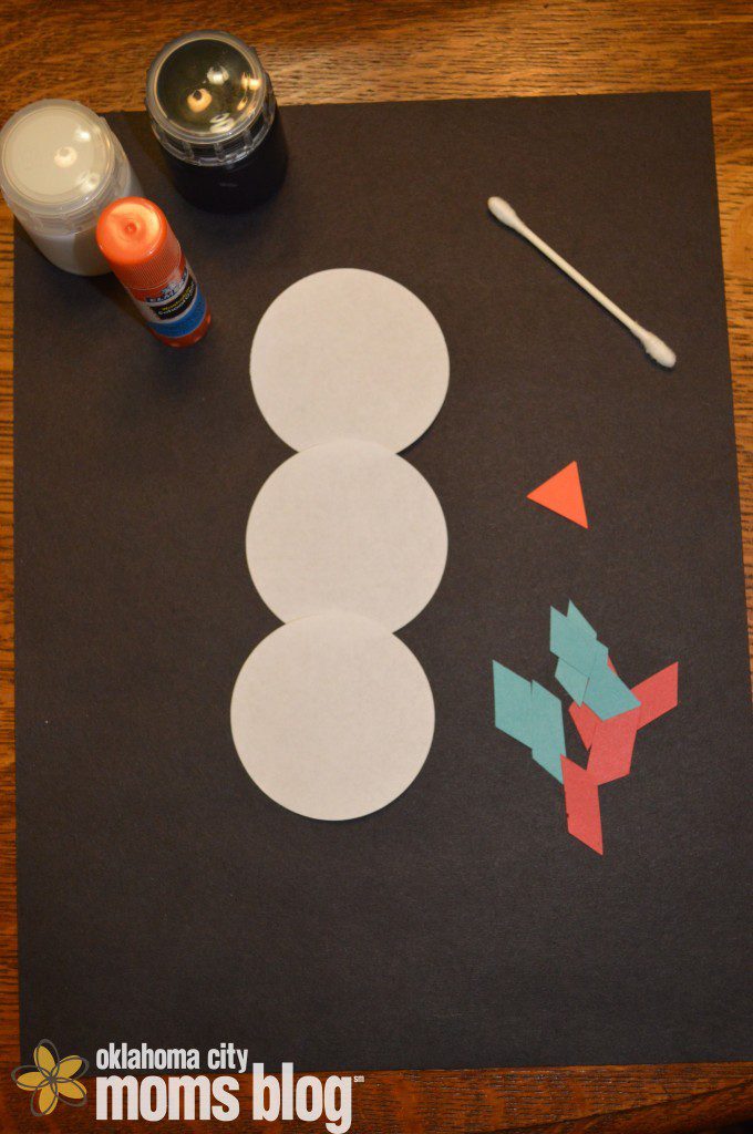 White and Black paint, one q-tip, glue, three white circles, colored construction paper, and orange construction