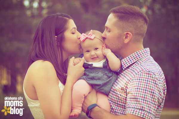 two people kissing baby